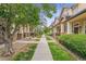 Charming street view of well-maintained homes with tree-lined sidewalks and inviting front porches at 1466 Turnberry Dr, Castle Rock, CO 80104