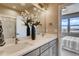 Bright bathroom with double sinks, modern lighting, and a large mirror at 6737 S Tempe Ct, Aurora, CO 80016
