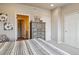 Comfortable bedroom featuring a patterned comforter, natural light, and a spacious closet at 6737 S Tempe Ct, Aurora, CO 80016