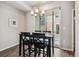 Cozy dining area with modern light fixture and sliding glass doors to outdoor space at 6737 S Tempe Ct, Aurora, CO 80016