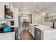 Charming kitchen with stainless steel appliances, white cabinetry, and a view into the adjacent dining area at 6737 S Tempe Ct, Aurora, CO 80016