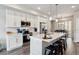 Bright kitchen featuring white cabinets, stainless steel appliances, and a large island with bar seating at 6737 S Tempe Ct, Aurora, CO 80016