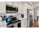 Close-up of kitchen with stainless steel appliances, white subway tile backsplash and modern finishes at 6737 S Tempe Ct, Aurora, CO 80016