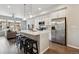 Open concept kitchen and living area with stainless appliances, island and sleek black stools at 6737 S Tempe Ct, Aurora, CO 80016