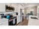Modern kitchen boasts stainless steel appliances, white cabinets, and sleek countertops at 6737 S Tempe Ct, Aurora, CO 80016