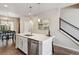 Stylish kitchen with a quartz countertop island, stainless steel appliances, and open floor plan at 6737 S Tempe Ct, Aurora, CO 80016