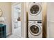 Convenient, stacked in-unit washer and dryer near a bedroom with a ceiling fan at 6737 S Tempe Ct, Aurora, CO 80016