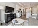 Open concept living space with white cabinets and stainless steel appliances in the kitchen at 6737 S Tempe Ct, Aurora, CO 80016