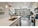 Bright, open-concept living space with a kitchen island and large windows at 6737 S Tempe Ct, Aurora, CO 80016