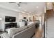 Open concept living space with white cabinets and stainless steel appliances in the kitchen at 6737 S Tempe Ct, Aurora, CO 80016