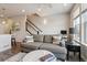 Comfortable living room with a couch and a marble coffee table near the staircase at 6737 S Tempe Ct, Aurora, CO 80016