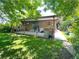 Spacious backyard featuring a covered patio area perfect for outdoor entertaining and leisure at 1115 S Harlan St, Lakewood, CO 80232