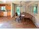 Cozy dining area adjacent to the kitchen, featuring a chandelier and a sliding glass door at 1115 S Harlan St, Lakewood, CO 80232