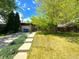 Charming home with mature trees, lovely landscaping, inviting curb appeal and a concrete driveway at 1115 S Harlan St, Lakewood, CO 80232