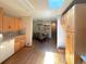 Bright kitchen featuring wood floors and cabinets, seamlessly connected to the dining area at 1115 S Harlan St, Lakewood, CO 80232
