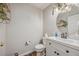 Powder room features white vanity, decorative mirror, and stylish fixtures at 12616 Jersey W Cir, Brighton, CO 80602