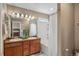Bathroom featuring double sinks, a shower over tub, and a neutral color palette at 12616 Jersey W Cir, Brighton, CO 80602