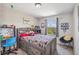 Bedroom featuring a bed with storage drawers, a desk, and a window at 12616 Jersey W Cir, Brighton, CO 80602