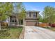 Beautiful home showcasing a well-maintained lawn, stone details, and an attached garage at 12616 Jersey W Cir, Brighton, CO 80602