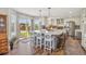 Open kitchen with a large granite island, modern appliances, and sliding glass doors leading to the backyard at 12616 Jersey W Cir, Brighton, CO 80602
