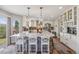 Bright kitchen featuring a spacious island with pendant lighting and a view to the living area at 12616 Jersey W Cir, Brighton, CO 80602