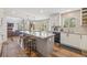Open concept kitchen features a large island with seating, stainless appliances, and natural light at 12616 Jersey W Cir, Brighton, CO 80602