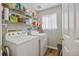 Laundry room with shelving, storage, washer, and dryer at 12616 Jersey W Cir, Brighton, CO 80602