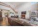 Spacious living room with vaulted ceiling, fireplace, and rich wood flooring at 12616 Jersey W Cir, Brighton, CO 80602