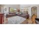 Open-concept living room with comfortable seating, hardwood floors, and lots of natural light at 12616 Jersey W Cir, Brighton, CO 80602