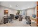 Spacious office area featuring dual workstations, a massage chair, and ample lighting for a productive work environment at 12616 Jersey W Cir, Brighton, CO 80602