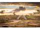 Community playground featuring two slides, natural landscaping, and stunning views at sunset at 21166 E 62Nd Dr, Aurora, CO 80019