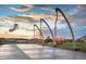 Unique orange swings in a community park, with modern design and a clean, safe play area for residents at 21166 E 62Nd Dr, Aurora, CO 80019