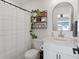 Stylish bathroom with organized shelving and contemporary fixtures, ideal for personal care at 503 S Rollie Ave # 12D, Fort Lupton, CO 80621
