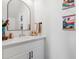 Chic half bath with a decorative mirror and wall art that creates a charming atmosphere at 503 S Rollie Ave # 12D, Fort Lupton, CO 80621
