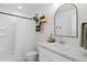 Bright bathroom with a white shower, vanity, mirror and neutral decor at 503 S Rollie Ave # 12D, Fort Lupton, CO 80621