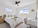 Bright bedroom featuring neutral decor, a ceiling fan, and a view of open fields at 503 S Rollie Ave # 12D, Fort Lupton, CO 80621