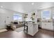 Inviting open concept space with island seating that connects the living room and the kitchen at 503 S Rollie Ave # 12D, Fort Lupton, CO 80621