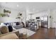 Bright open concept living area with modern decor, wood floors, and seamless flow to the kitchen at 503 S Rollie Ave # 12D, Fort Lupton, CO 80621