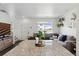 Open layout with granite island and hardwood floors that joins the living room and kitchen area at 503 S Rollie Ave # 12D, Fort Lupton, CO 80621