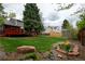A beautifully landscaped backyard with a deck, lush lawn, mature trees, and storage shed at 7334 S Moore St, Littleton, CO 80127