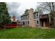 Spacious backyard with brick chimney, wood deck and a lush green lawn at 7334 S Moore St, Littleton, CO 80127