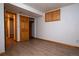 Finished basement area with wood-look flooring, natural light, and ample storage at 7334 S Moore St, Littleton, CO 80127
