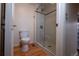 Bathroom featuring a glass enclosed shower, toilet, and stylish fixtures at 7334 S Moore St, Littleton, CO 80127