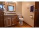 Cozy bathroom with wood floors, wood vanity and a granite countertop at 7334 S Moore St, Littleton, CO 80127