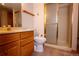 Bathroom featuring wood vanity and shower with glass door at 7334 S Moore St, Littleton, CO 80127