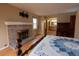 Inviting primary bedroom with fireplace, hardwood floors, and ensuite bathroom at 7334 S Moore St, Littleton, CO 80127