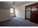 Bedroom with angled ceilings, blue carpet and closet for a cozy retreat at 7334 S Moore St, Littleton, CO 80127