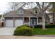 Charming two-story home with a brick facade, a well-manicured lawn, and a two-car garage at 7334 S Moore St, Littleton, CO 80127