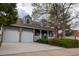 Charming two-story home with a brick facade, a well-manicured lawn, and a two-car garage at 7334 S Moore St, Littleton, CO 80127
