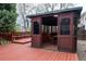 Backyard gazebo featuring dark trim, sliding doors, and exterior deck at 7334 S Moore St, Littleton, CO 80127